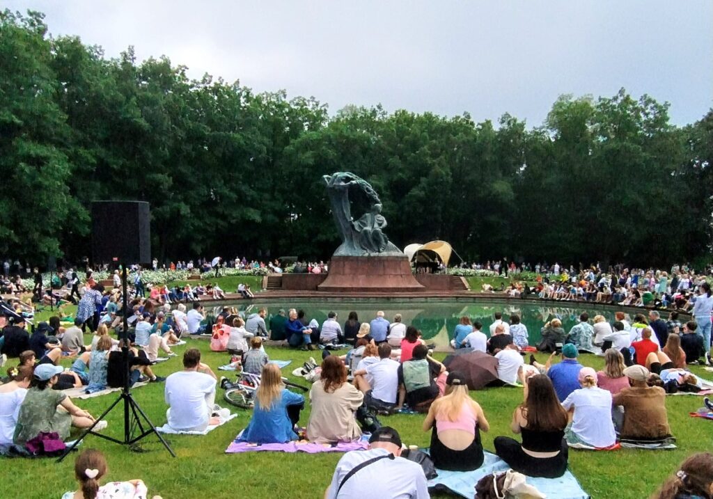 Il prato gremito di spettatori di fronte alla statua di Chopin mentre un pianista suona le opere del compositore polacco, Varsavia, 2 Giugno 2024. Meridiano13/Oscar Luigi Guccione